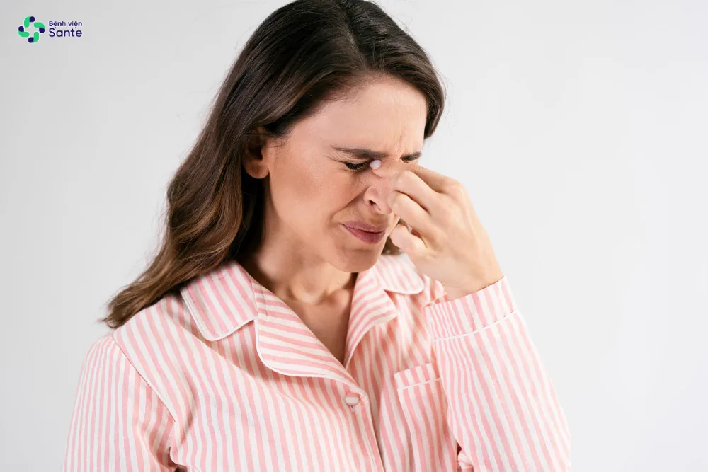 A woman experiencing discomfort due to severe unilateral nasal obstruction while lying down to sleep